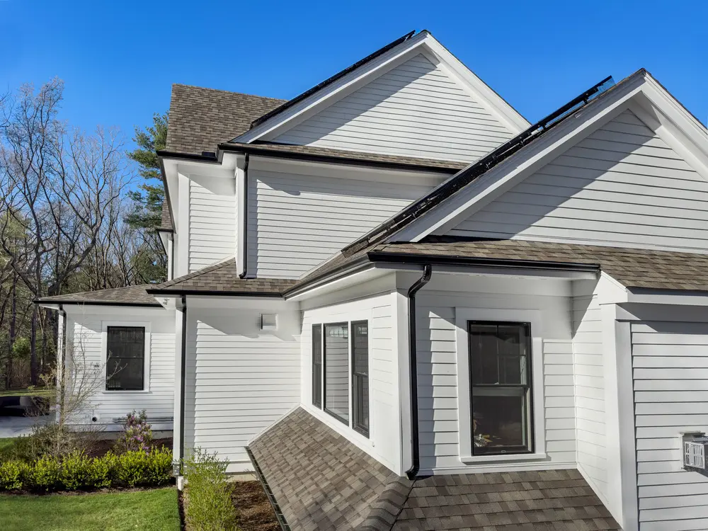 Wire mesh critter guards around solar panel arrays on a suburban home's roof